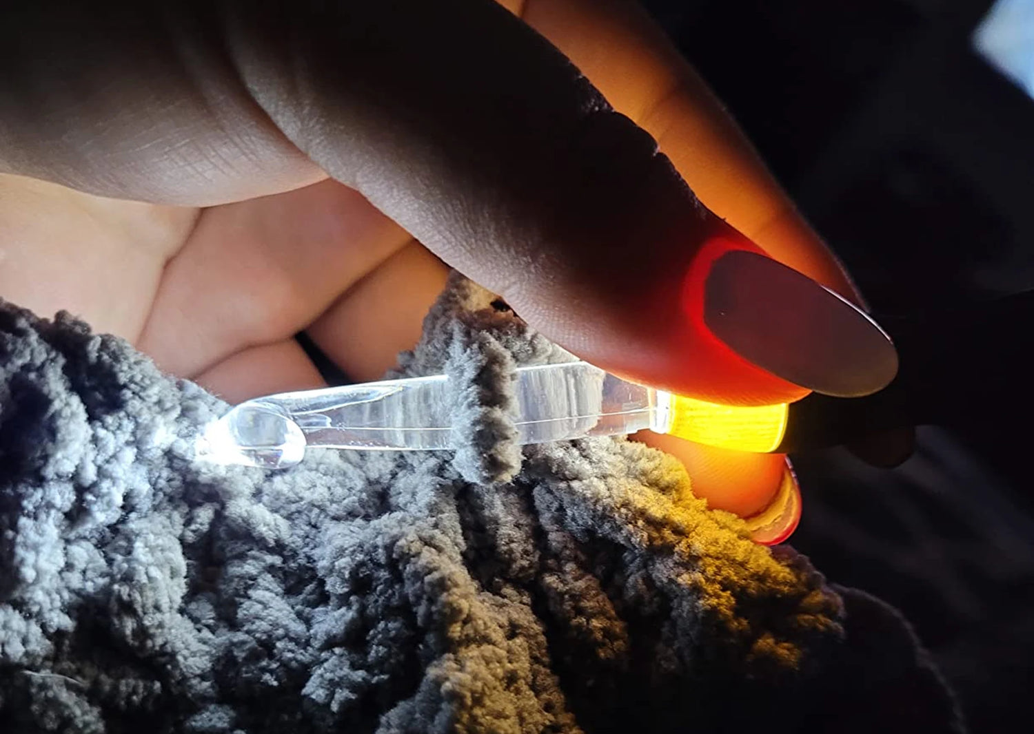 LED crochet hook lighting up yarn so you can see every stitch while crocheting at night.